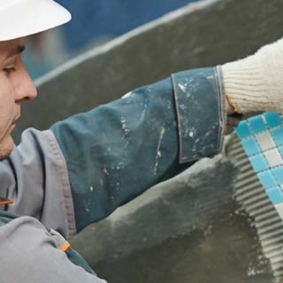 California Pool Association Pool Construction & Remodel Insurance Page Banner – Swimming Pool Construction Worker Installing Pool Tiles